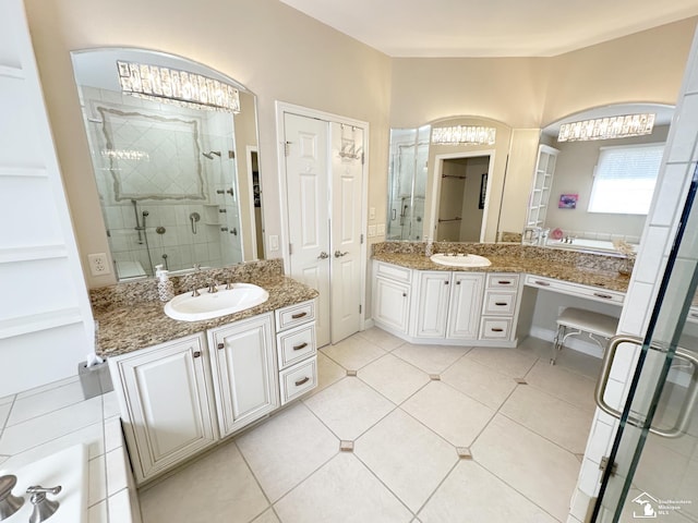 full bath with an inviting chandelier, a shower stall, a sink, and two vanities
