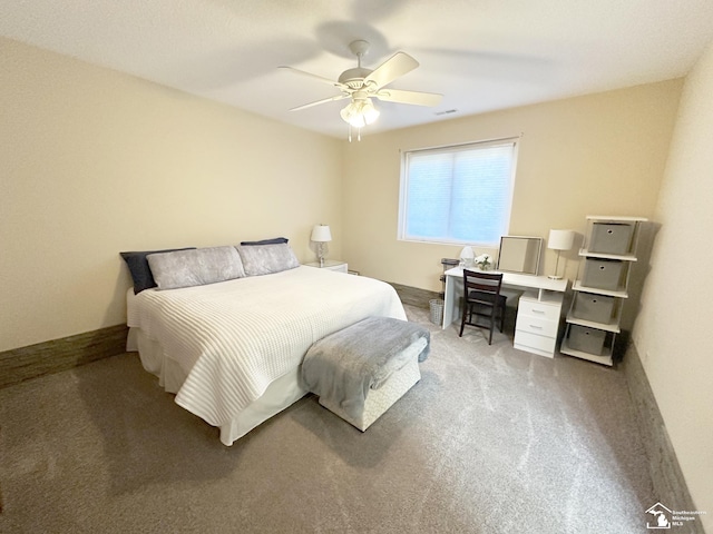 carpeted bedroom with ceiling fan and baseboards