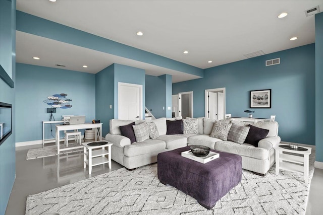 living area with recessed lighting, baseboards, visible vents, and stairway