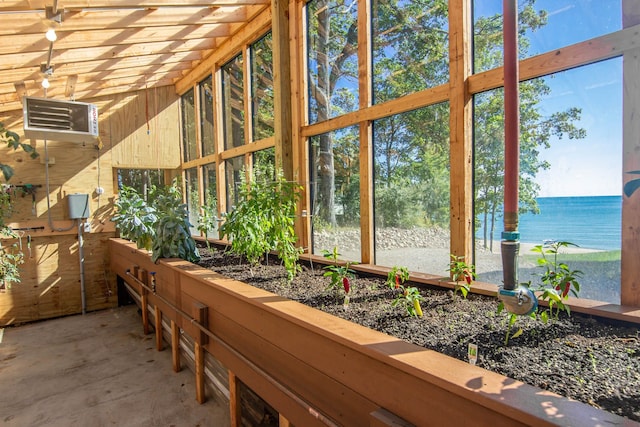 sunroom / solarium featuring a water view