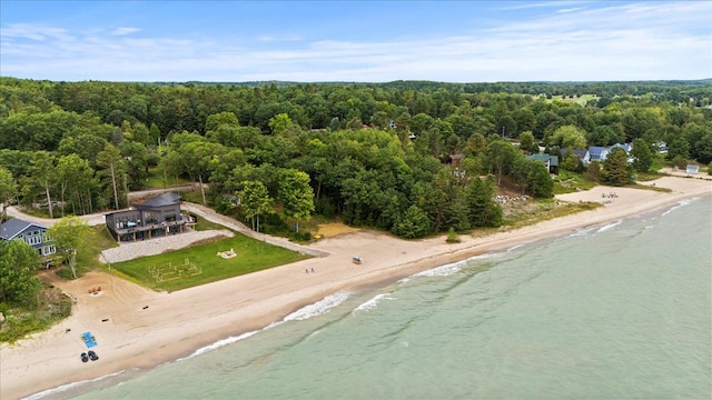 bird's eye view featuring a beach view, a water view, and a forest view