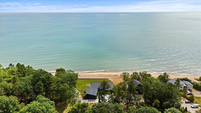 birds eye view of property featuring a water view and a beach view