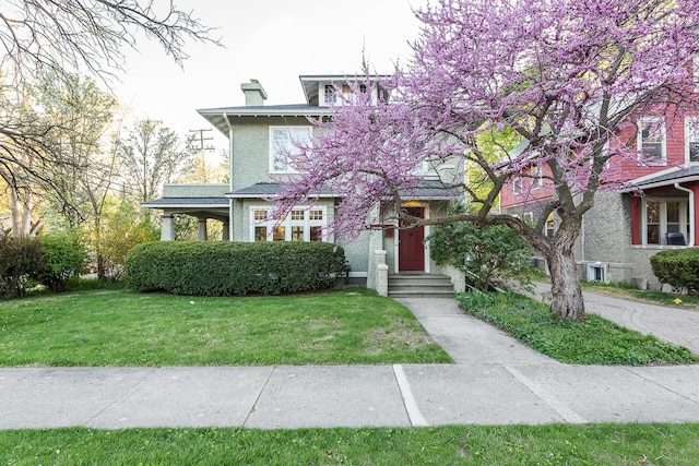view of front of house featuring a chimney and a front lawn