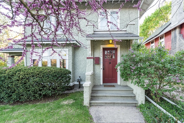 property entrance with stucco siding