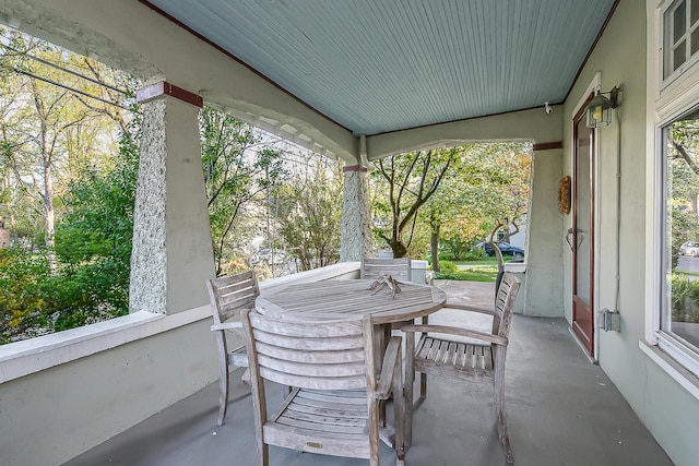 sunroom featuring outdoor dining area