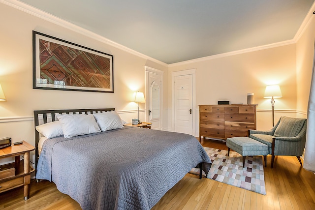 bedroom with crown molding and wood-type flooring