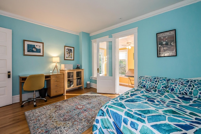 bedroom with baseboards, ornamental molding, and wood finished floors