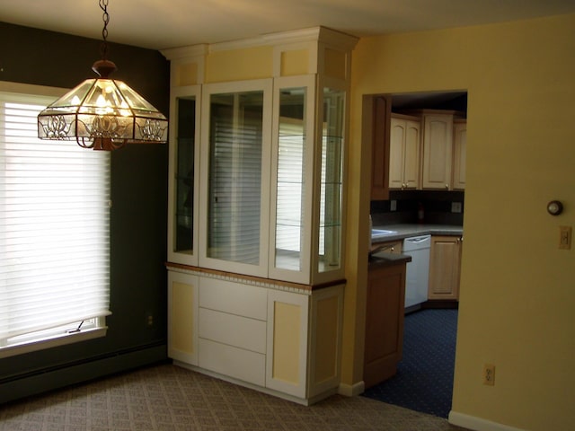 unfurnished dining area with a chandelier, baseboards, a baseboard heating unit, and carpet