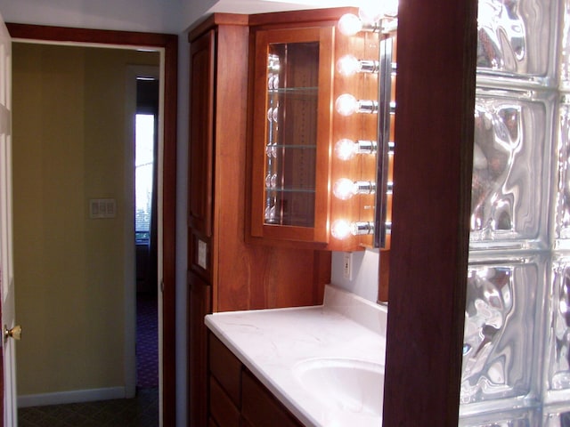 bathroom with vanity and baseboards