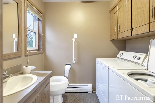 laundry area with washer and dryer, laundry area, a sink, baseboard heating, and carpet floors