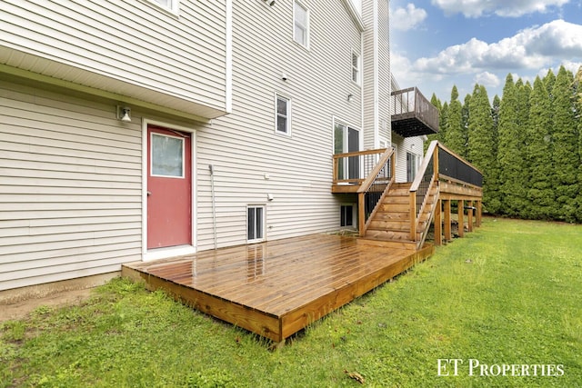 wooden deck with a lawn and stairs