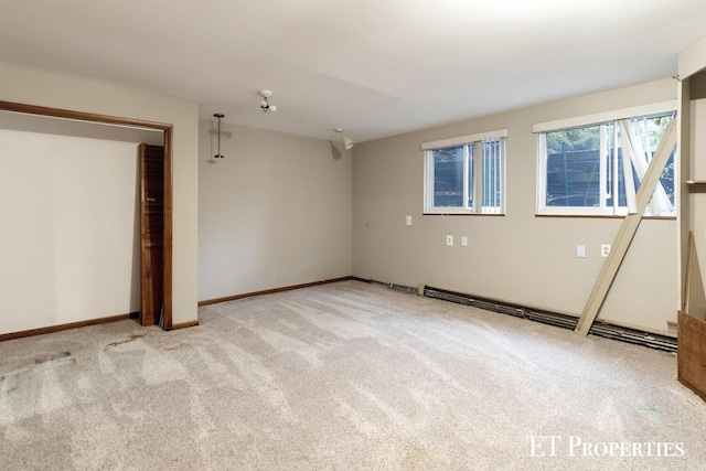 unfurnished bedroom featuring baseboards and carpet