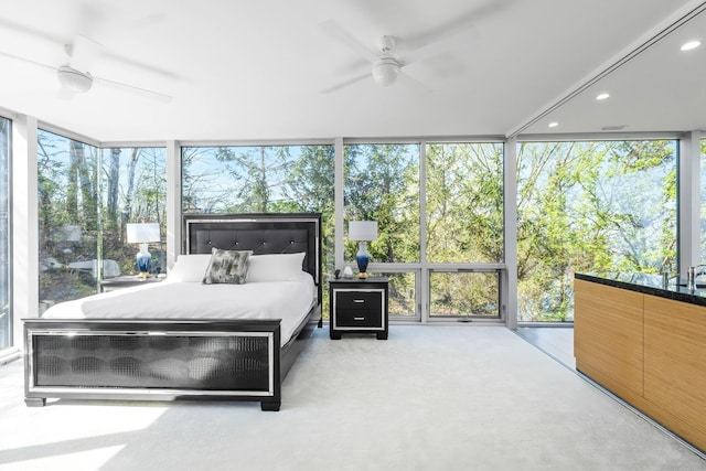 bedroom featuring recessed lighting, multiple windows, and a wall of windows