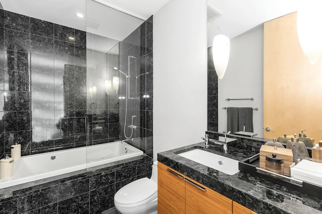 full bathroom featuring vanity, toilet, and tiled shower / bath combo