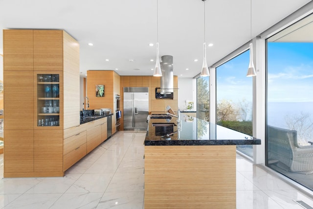 kitchen featuring marble finish floor, a kitchen island, modern cabinets, island range hood, and stainless steel built in refrigerator