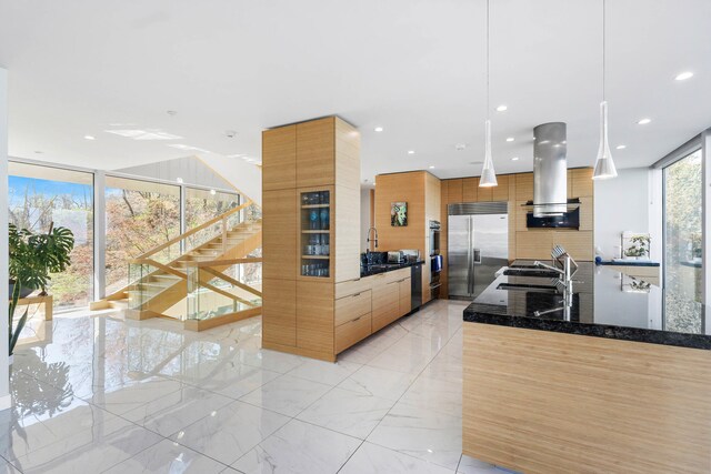 kitchen with marble finish floor, recessed lighting, island exhaust hood, built in refrigerator, and modern cabinets