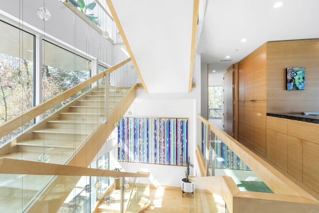 stairs featuring recessed lighting and wood finished floors