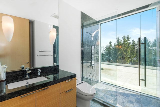 full bath featuring vanity, a stall shower, and toilet
