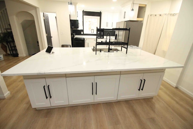 17150 Santa Barbara Dr, Detroit, MI 48221 - kitchen with a sink, light wood finished floors, white cabinets, a spacious island, and baseboards