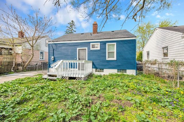 16044 Liberal St, Detroit, MI 48205 - back of property featuring a wooden deck, a chimney, and fence