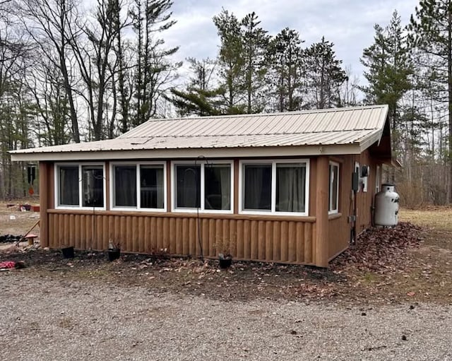 view of side of home featuring metal roof
