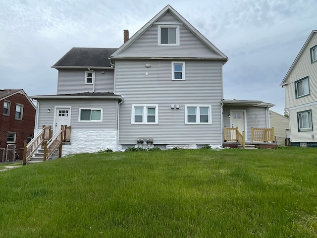 171 Davis St, Wyandotte, MI 48192 - rear view of property with a chimney, a lawn, and a shingled roof