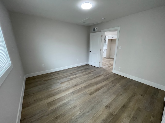 171 Davis St, Wyandotte, MI 48192 - spare room featuring attic access, wood finished floors, and baseboards