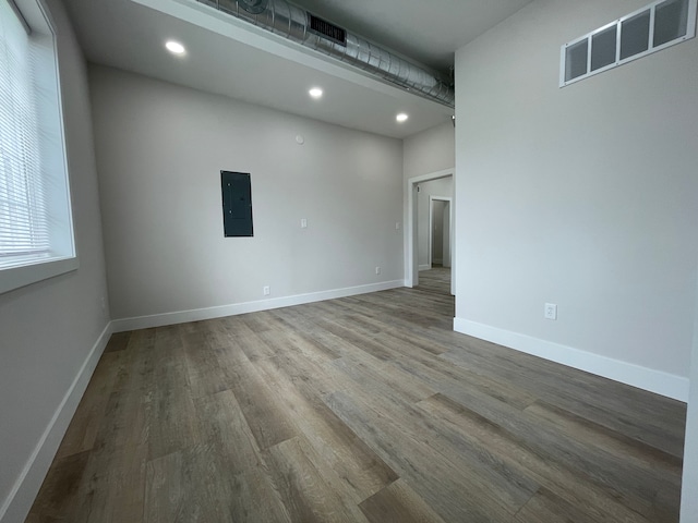 171 Davis St, Wyandotte, MI 48192 - empty room featuring electric panel, wood finished floors, baseboards, and recessed lighting