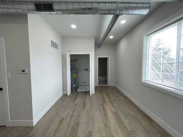 171 Davis St, Wyandotte, MI 48192 - unfurnished room with water heater, wood finished floors, healthy amount of natural light, and recessed lighting