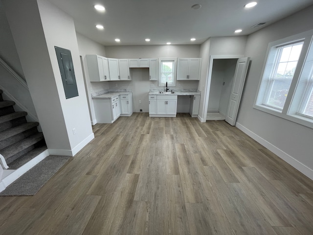 171 Davis St, Wyandotte, MI 48192 - kitchen featuring a sink, white cabinetry, light wood finished floors, baseboards, and recessed lighting