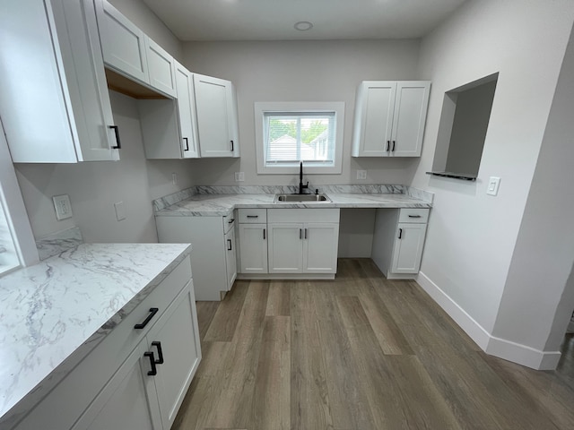 171 Davis St, Wyandotte, MI 48192 - kitchen featuring wood finished floors, a sink, white cabinets, and baseboards