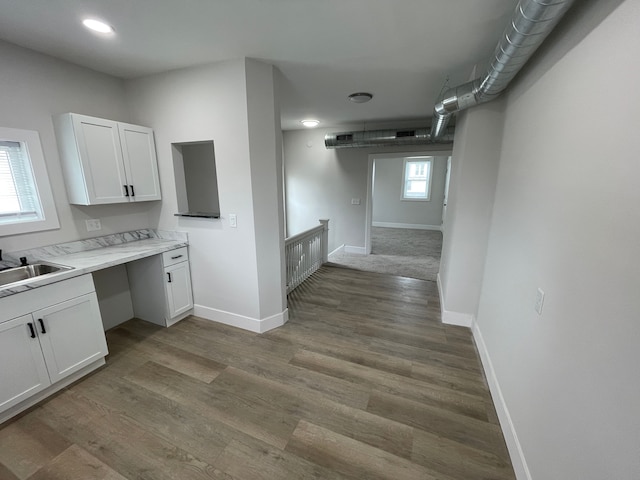 171 Davis St, Wyandotte, MI 48192 - kitchen featuring a sink, white cabinetry, baseboards, light countertops, and wood finished floors
