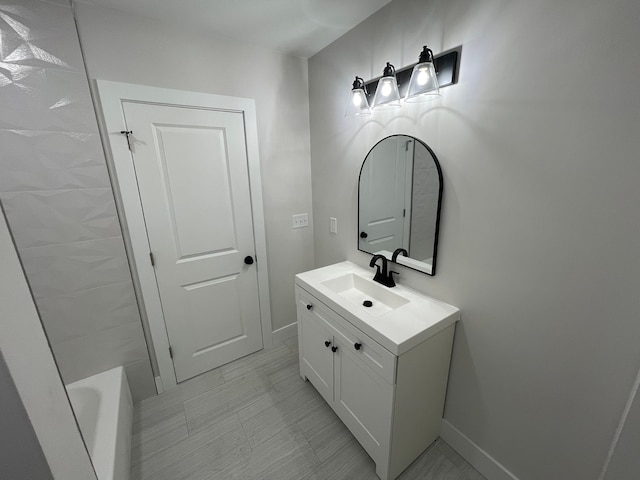 171 Davis St, Wyandotte, MI 48192 - bathroom with vanity, baseboards, and a bathtub