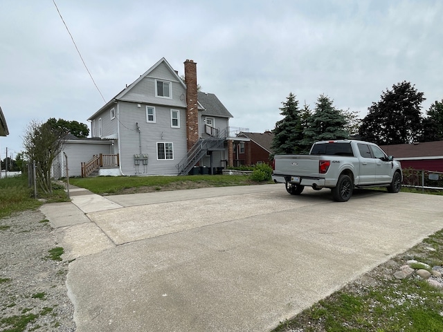 171 Davis St, Wyandotte, MI 48192 - view of side of home featuring a chimney and stairs