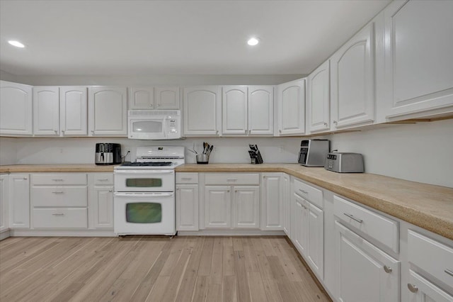 kitchen featuring white appliances, white cabinetry, recessed lighting, light wood-type flooring, and light countertops