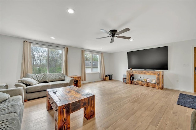living room with ceiling fan, light wood-type flooring, recessed lighting, and baseboards