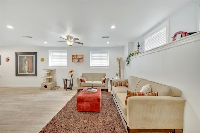 living room featuring ceiling fan, recessed lighting, baseboards, and light wood-type flooring