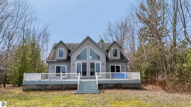 back of house with a lawn and a deck