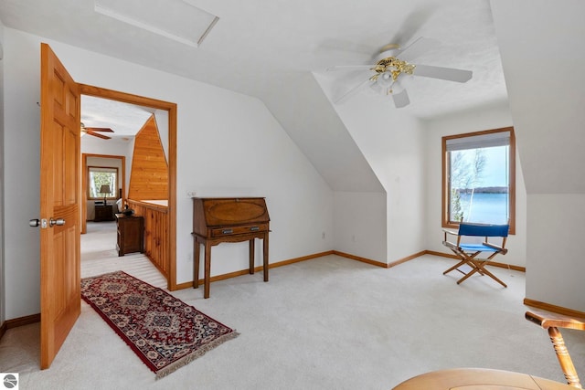 additional living space with ceiling fan, vaulted ceiling, light carpet, and baseboards