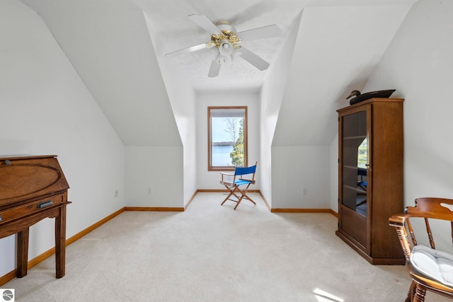 additional living space with baseboards, light carpet, and vaulted ceiling