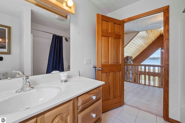 bathroom with vanity, tile patterned floors, curtained shower, lofted ceiling, and a water view