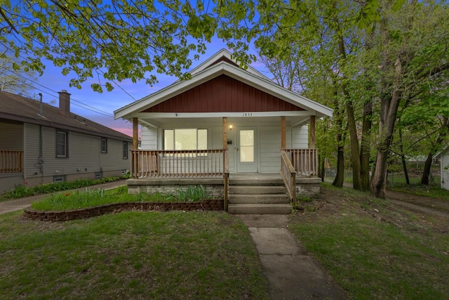 bungalow-style house with a porch and a front yard