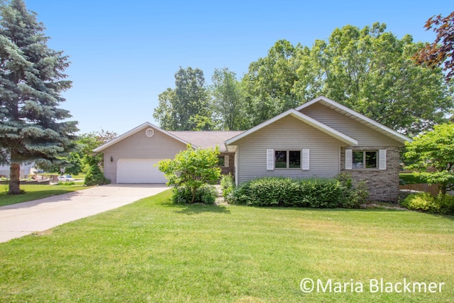 ranch-style home featuring a garage, driveway, and a front yard