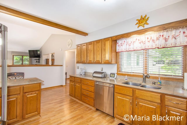 kitchen featuring brown cabinetry, stainless steel dishwasher, a sink, light countertops, and vaulted ceiling with beams