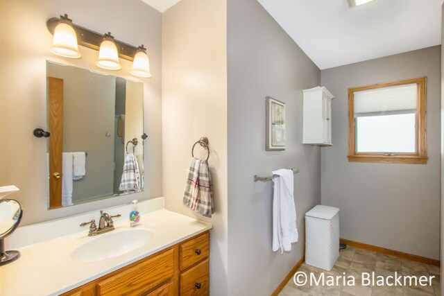 bathroom featuring baseboards and vanity