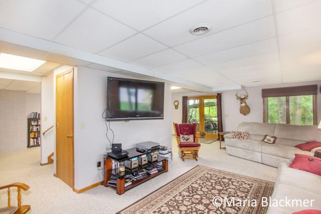 carpeted living room featuring visible vents and a drop ceiling