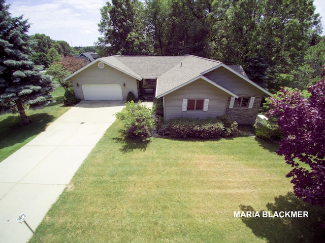ranch-style house with a garage, driveway, and a front yard