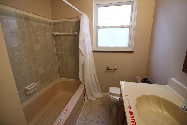 full bath with vanity, toilet, tile patterned floors, baseboards, and shower / tub combo