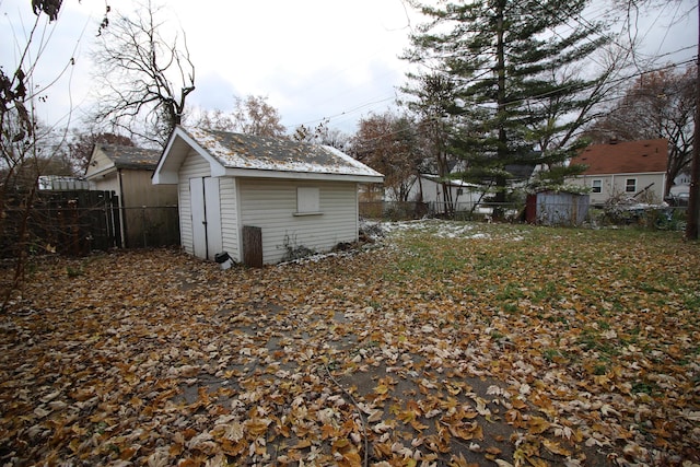 exterior space featuring fence, an outbuilding, and a shed