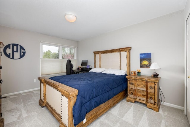 bedroom featuring baseboards and light carpet